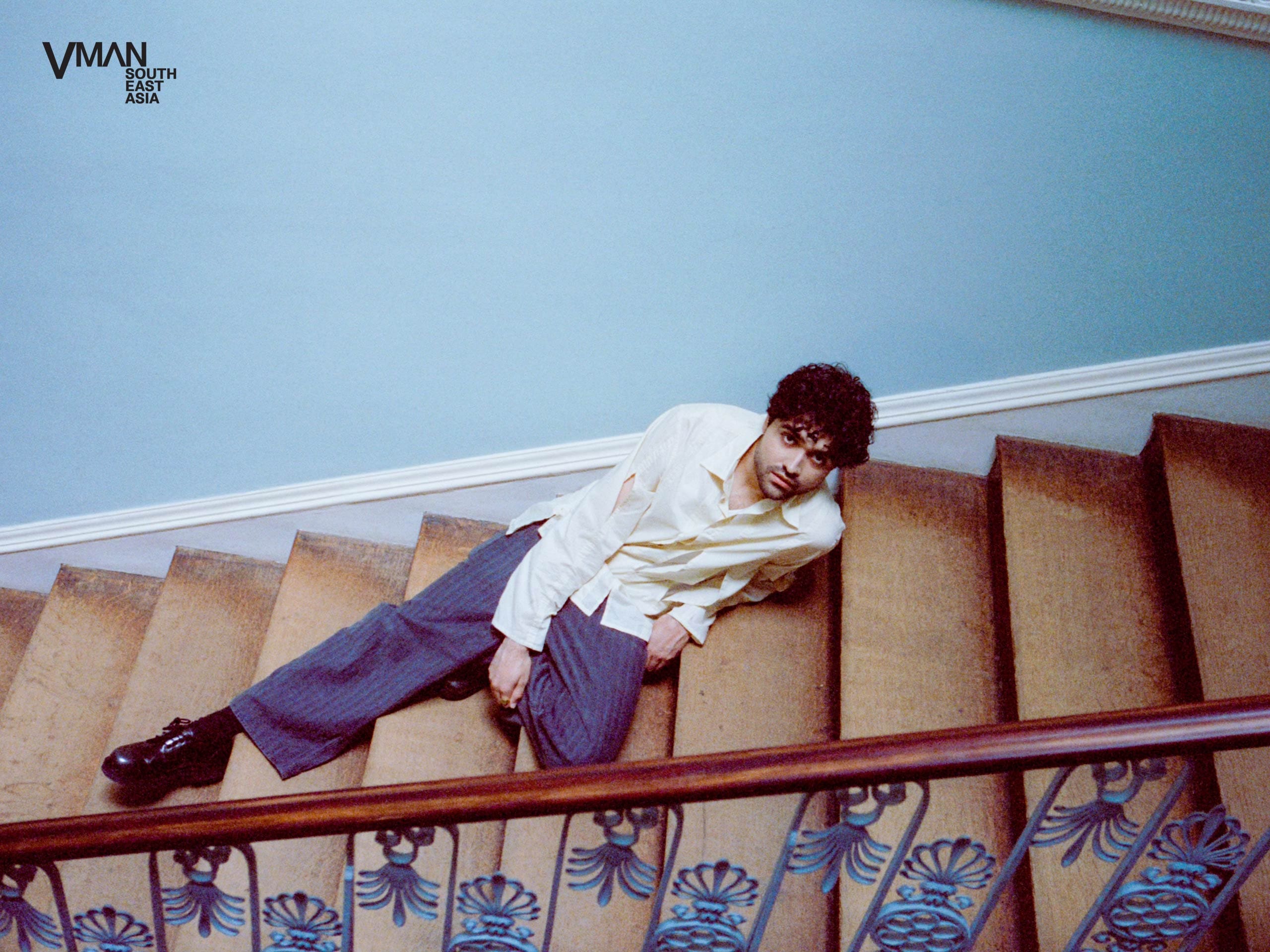 Dhruv posing on a staircase