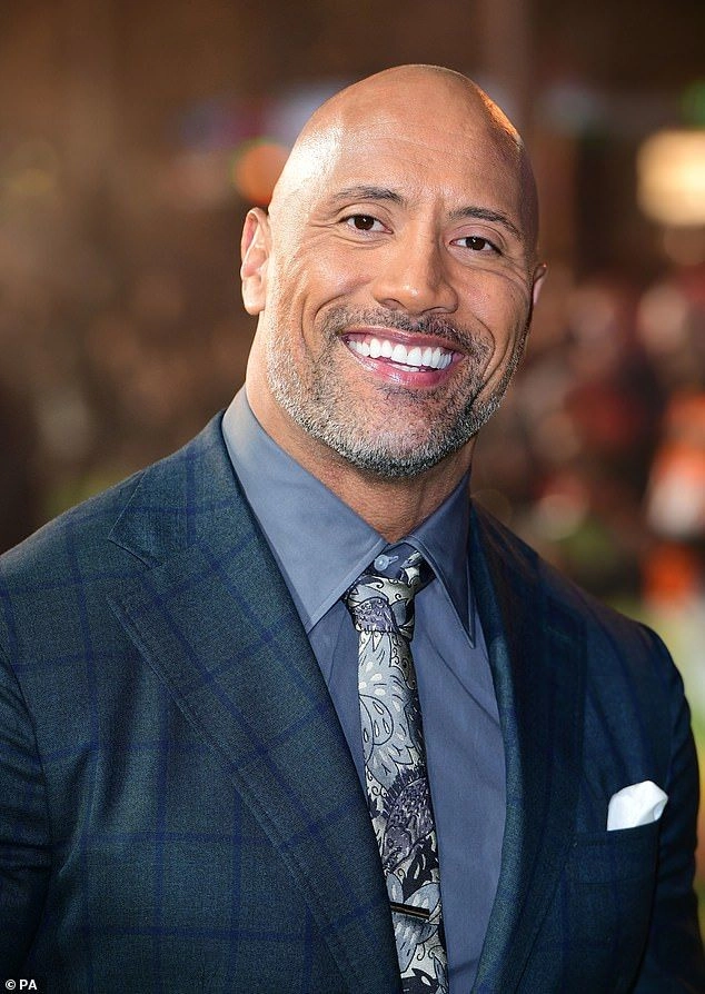 Bald man in a suit smiling 