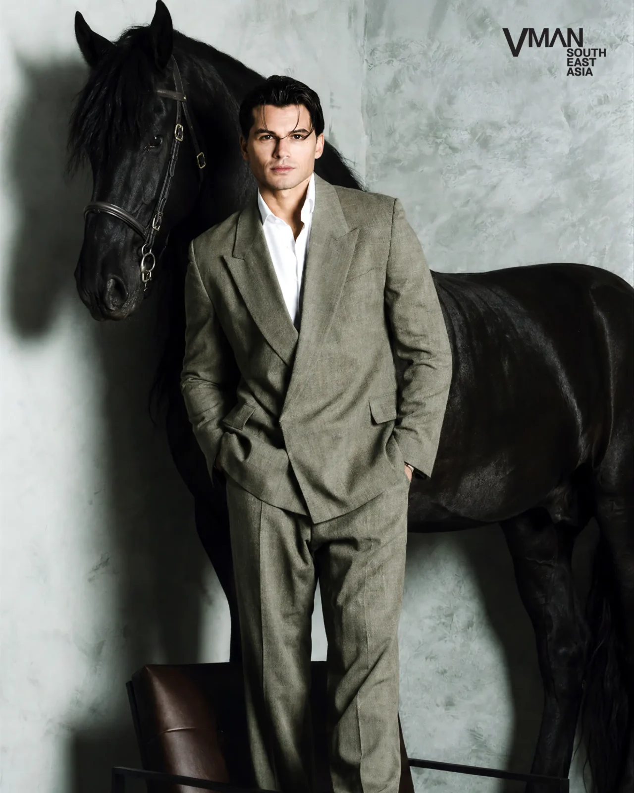 antonio medugno with a horse wearing green suit